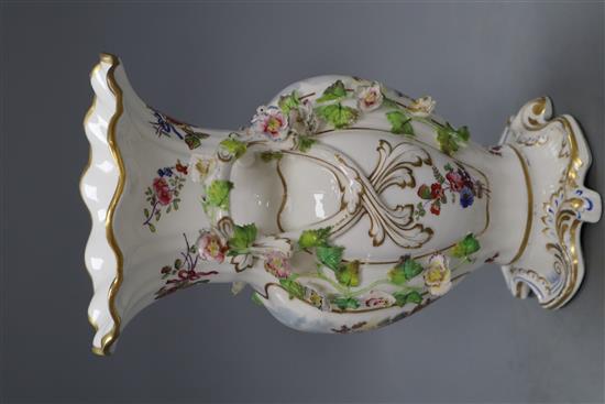 A late 19th century English bone china double handled vase, encrusted with flowers and having frilled rim heightened in gilt, topograph